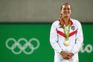RIO DE JANEIRO, BRAZIL - AUGUST 13:  Gold medalist Monica Puig of Puerto Rico reacts during the medal ceremony for Women's Singles on Day 8 of the Rio 2016 Olympic Games at the Olympic Tennis Centre on August 13, 2016 in Rio de Janeiro, Brazil.  (Photo by Clive Brunskill/Getty Images)